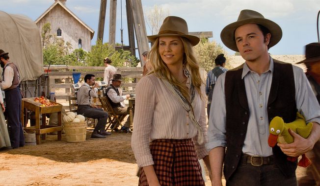 Seth MacFarlane (right) starring as sheep farmer Albert, is joined by Charlize Theron in a scene from &quot;A Million Ways to Die in the West.&quot; Mr. MacFarlane also directed and co-wrote the movie, which is at once a deeply crude movie and a surprisingly sweet one. (Universal Pictures via Associated Press)