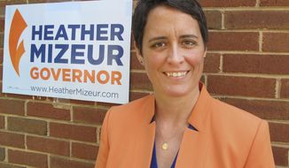 In this photo taken on Monday, May 19, 2014, Heather Mizeur, who is running in Maryland&#x27;s Democratic primary for governor, stands in front of her campaign office in Silver Spring, Md.  Mizeur is campaigning to become Maryland’s first female governor and the first openly gay governor in the nation. She is running against Lt. Gov. Anthony Brown and Attorney General Doug Gansler in the primary, which is June 24. (AP Photo/Brian Witte)