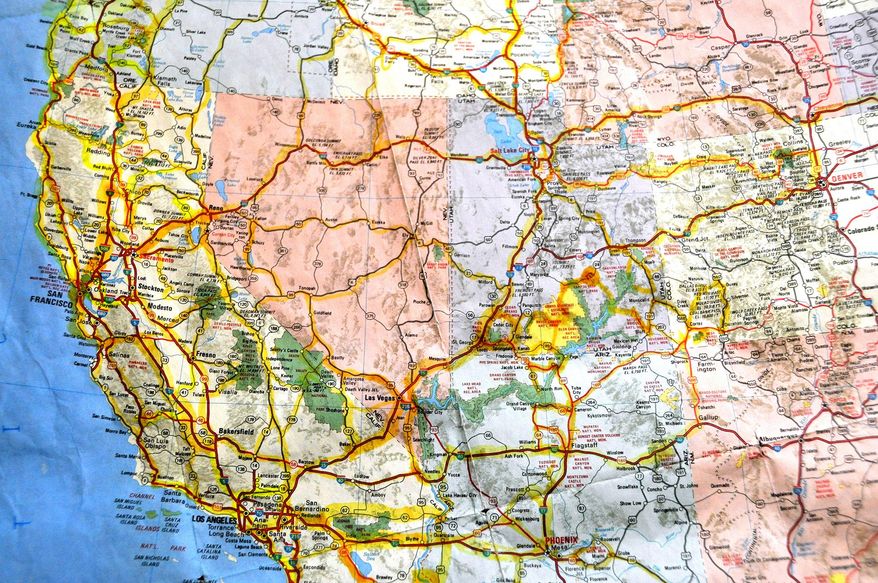 In this May 20, 2014 photo, a map of the United States is highlighted in yellow where Susan and Larry Dach have traveled and camped since retiring in 2008. The Dachs are the 2014 summer campground hosts at Dragoon Campground north of Spokane. They have cut costs by earning free camping as hosts, and say they're planning their future trips to cover the South. (AP Photo/The Spokesman-Review, Rich Landers) COEUR D'ALENE PRESS OUT