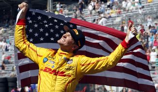 10ThingstoSeeSports - Ryan Hunter-Reay celebrates after winning the 98th running of the Indianapolis 500 IndyCar auto race at the Indianapolis Motor Speedway in Indianapolis, Sunday, May 25, 2014. (AP Photo/Tom Strattman, File)