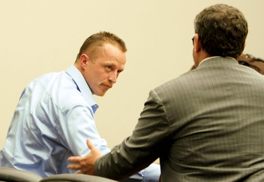 Nicholas Sheley shakes hands with his defense attorney, Jeremy Karlin, after he was found guilty Thursday, May 29, 2014, in Rock Island, Ill., in the deaths in the deaths of 29-year-old Brock Branson; 20-year-old Kilynna Blake; her son, 2-year-old Dayan; and 25-year-old Kenneth Ulve in Rock Falls in June 2008. (AP Photo/Quad-City Times, Kevin E. Schmidt) MAGS OUT, TV OUT, NO SALES.