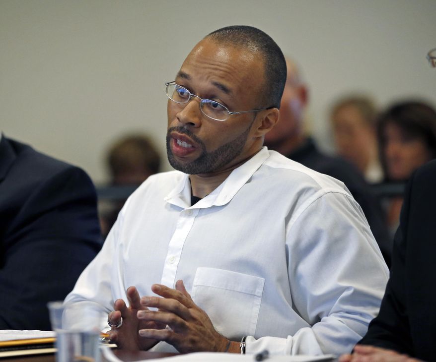 Frederick Christian speaks on his own behalf during a hearing before the state's parole board in Natick, Mass., Thursday, May 29, 2014. Christian, who has been in prison for twenty years for a premeditated robbery which resulted in two dead and one injured, is appealing for release after Massachusetts' highest court struck down mandatory life sentences for juveniles in December. (AP Photo/Elise Amendola)
