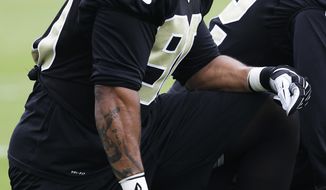 New Orleans Saints outside linebacker Victor Butler (90) takes a knee during an NFL football minicamp in Metairie, La., Thursday, May 29, 2014. Butler missed the entire 2013 due to a knee injury. (AP Photo/Bill Haber)