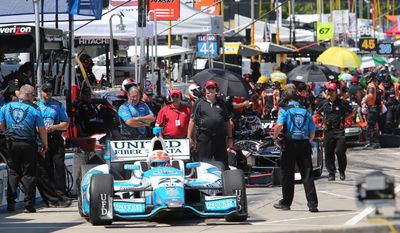 Driver James Hinchcliffe leaves the pit stall during a practice session for the IndyCar Detroit Grand Prix auto race on Belle Isle in Detroit, Friday, May 30, 2014. (AP Photo/Dave Frechette)