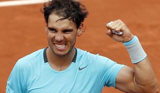 Spain&#39;s Rafael Nadal clenches his fist after defeating Austria&#39;s Dominic Thiem during the second round match of  the French Open tennis tournament at the Roland Garros stadium, in Paris, France, Thursday, May 29, 2014. Nadal won 6-2, 6-2, 6-3. (AP Photo/Darko Vojinovic)
