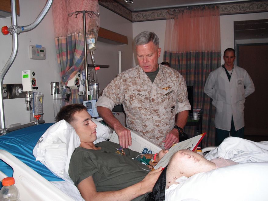 ADVANCE FOR WEEKEND EDITIONS, JUNE 1-2 - In this 2009 photo provided by Monster Energy, Jesse Williamson receives his purple heart citation from Commandant General Amos of the USMC at Walter Reed National Military Medical Center in Bethesda, Md. Next weekend, Williamson will attempt to become the first double amputee to compete in the Baja 500 off-road race through Mexico. (AP Photo/Monster Energy)
