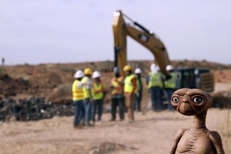 FILE - In this April 26, 2014 file photo, an E.T. doll is seen while construction workers prepare to dig into a landfill in Alamogordo, N.M., Producers of a documentary dug in an southeastern New Mexico landfill in search of millions of cartridges of the Atari 'E.T. the Extra-Terrestrial' game that has been called the worst game in the history of video gaming and were buried there in 1983.  Officials in  Alamogordo, are working on a plan under which film companies, museums and the public could get Atari video games that were dug up from the old landfill last month. (AP Photo/Juan Carlos Llorca)
