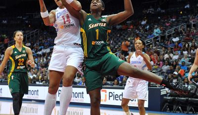 Atlanta Dream&#39;s Erika de Souza and Seattle Storm&#39;s Crystal Langhorne vie for a rebound during a WNBA basketball game Friday, May 30, 2014, in Atlanta. (AP Photo/Atlanta Journal Constitution, Brant Sanderlin) GWINNETT OUT  MARIETTA OUT   LOCAL TV OUT (WXIA, WGCL, FOX 5)