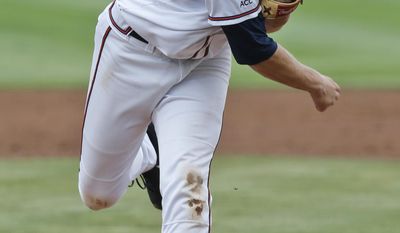 Virginia pitcher Artie Lewicki (34) pitches during the second inning of an NCAA College regional tournament baseball game against Bucknell in Charlottesville, Va., Friday, May 30, 2014.   (AP Photo/Steve Helber)