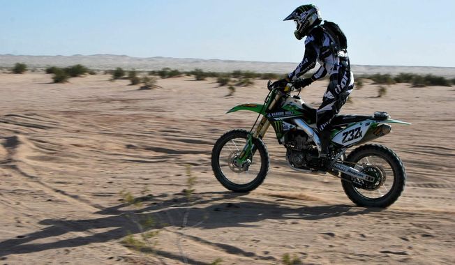 ADVANCE FOR WEEKEND EDITIONS, JUNE 1-2 - In this April, 2014 photo provided by Monster Energy, double-amputee Jesse Williamson races in the Imperial Valley 250 in Plaster City, Calif.  Williamson's legs. PTSD haunted him. Addiction left him apathetic. Climbing back onto a dirt bike and racing across the desert changed everything for the former Marine. "I feel alive again," Williamson said. "It's like a new experience every time." (AP Photo/Monster Energy)
