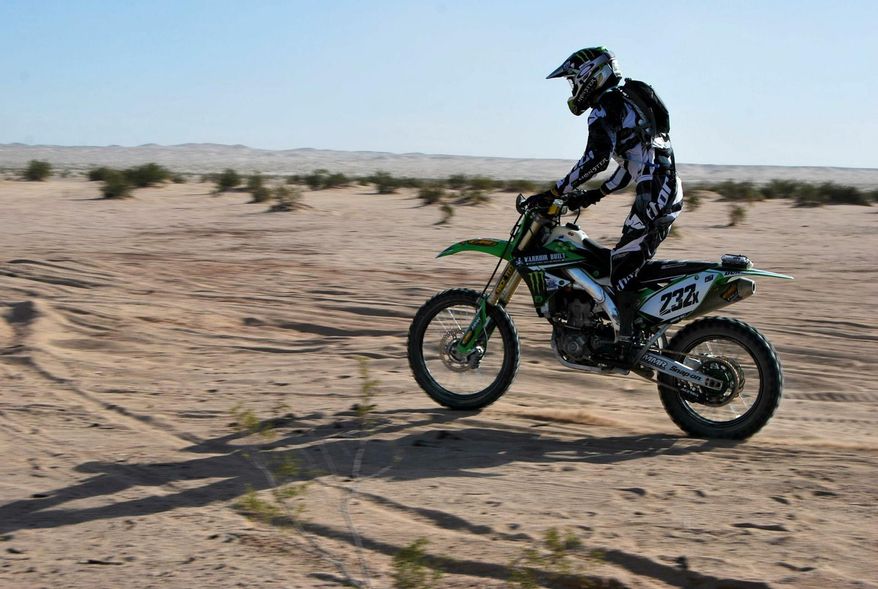 ADVANCE FOR WEEKEND EDITIONS, JUNE 1-2 - In this April, 2014 photo provided by Monster Energy, double-amputee Jesse Williamson races in the Imperial Valley 250 in Plaster City, Calif. Williamson's legs. PTSD haunted him. Addiction left him apathetic. Climbing back onto a dirt bike and racing across the desert changed everything for the former Marine. "I feel alive again," Williamson said. "It's like a new experience every time." (AP Photo/Monster Energy)