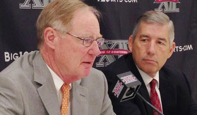 Oklahoma State President and Chairman of the Big 12 board of directors Burns Hargis, , left, and Big 12 Commissioner Bob Bowlsby, talk at the end of the Big 12 meetings at the Four Seasons Resort and Hotel in Irving, Texas, on Friday, May 30, 2014. (AP Photo/Stephen Hawkins)