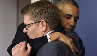 President Barack Obama gives White House press secretary Jay Carney a hug after announcing that Carney will step down later next month, during a surprise visit to the Brady Press Briefing Room of the White House, Friday, May 30, 2014. The president announced Carney&#39;s departure in a surprise appearance at in the White House press briefing room Friday. He said principal deputy press secretary Josh Earnest will take over the job. (AP Photo/Susan Walsh)