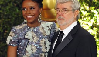 FILE - In this Nov. 16, 2013 file photo, filmmaker George Lucas and his wife, Chicago native Mellody Hobson, are seen on the red carpet at the 2013 Governors Awards in Los Angeles. Chicago Mayor Rahm Emanuel is trying to persuade the “Star Wars” creator to put his planned museum of art and movie memorabilia in Chicago and is offering up a slice of real estate along the Lake Michigan shorefront where it would be located. A competing bid from San Francisco seems a more natural fit: it’s Lucas’ hometown, it’s a premier center of technology and innovation and it’s closer to the nation’s movie-making heartland. (Photo by John Shearer/Invision/AP)