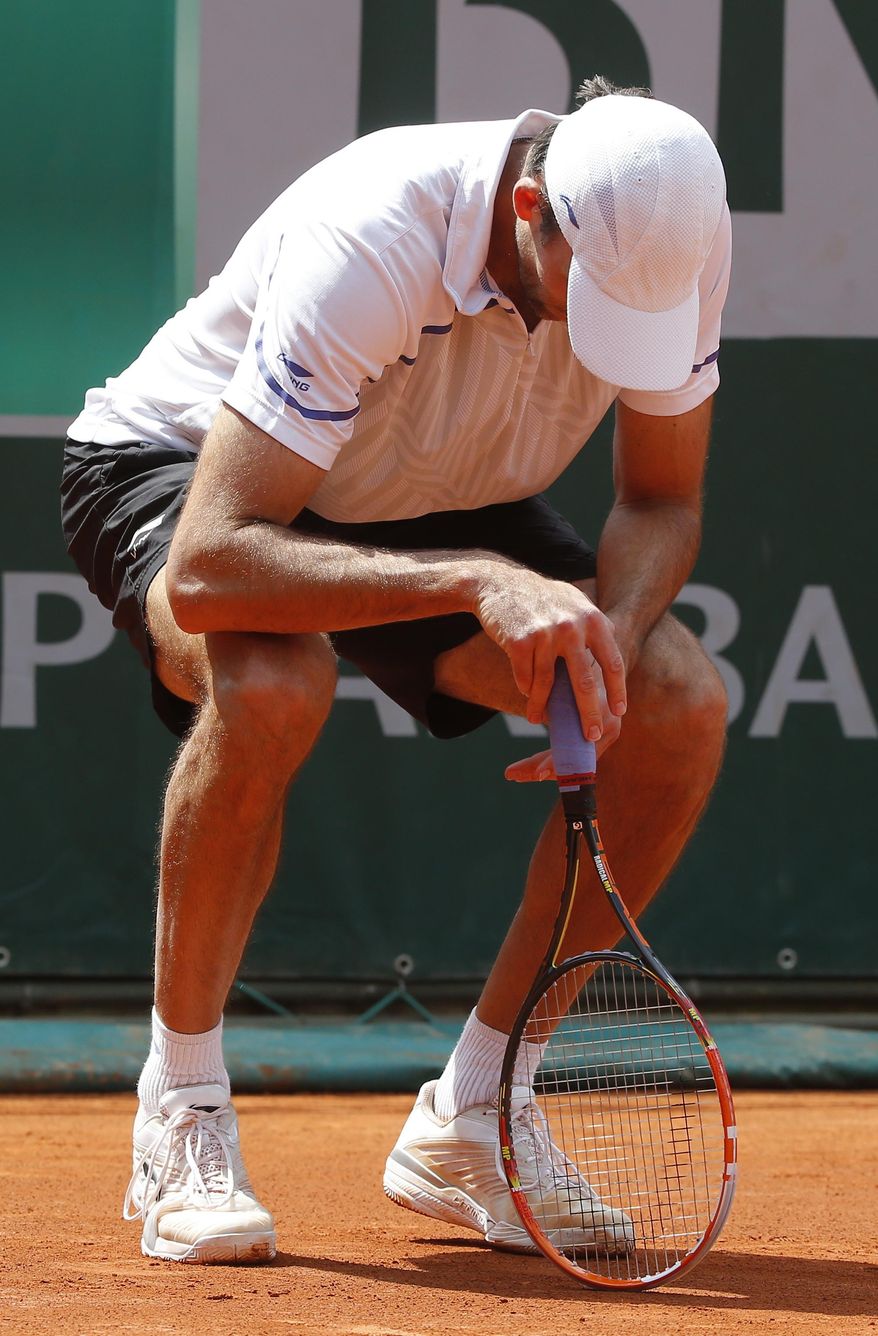 Croatia&#x27;s Ivo Karlovic looks down as he plays South Africa&#x27;s Kevin Anderson during their third round match of  the French Open tennis tournament at the Roland Garros stadium, in Paris, France, Saturday, May 31, 2014. (AP Photo/Michel Euler)