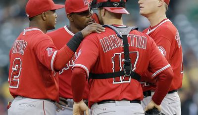 Los Angeles Angels starting pitcher Garrett Richards, right, talks with teammates Chris Iannetta (17), Howie Kendrick, second from left, and Erick Aybar (2) on the mound after walking the bases loaded against the Oakland Athletics during the first inning of a baseball game Friday, May 30, 2014, in Oakland, Calif. (AP Photo/Marcio Jose Sanchez)