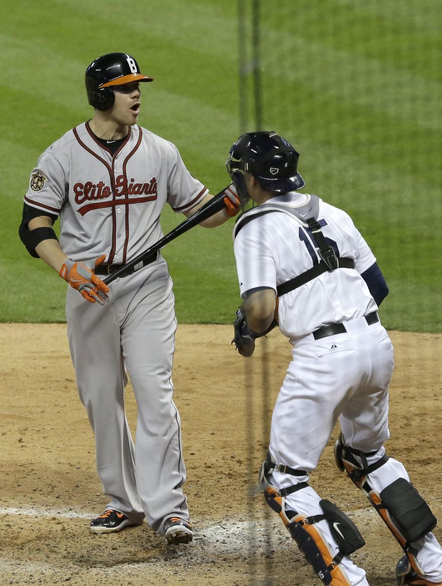 Baltimore Orioles&#39; Chris Davis, left, reacts to being called out on strikes as Houston Astros catcher Jason Castro heads to the field to celebrate a 2-1 win in Major League baseball&#39;s annual Civil Rights Game Friday, May 30, 2014, in Houston. (AP Photo/Pat Sullivan)