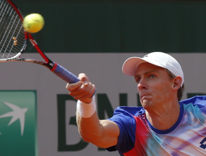 South Africa&#x27;s Kevin Anderson returns the ball to Croatia&#x27;s Ivo Karlovic during their third round match of  the French Open tennis tournament at the Roland Garros stadium, in Paris, France, Saturday, May 31, 2014. (AP Photo/Michel Euler)