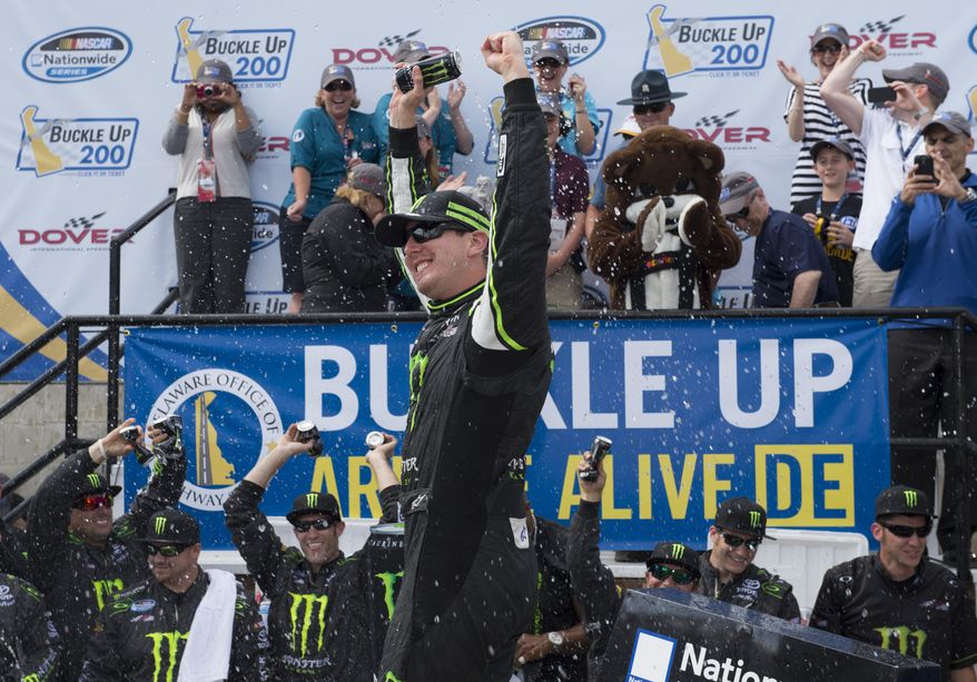 Kyle Busch celebrates in Victory Lane after winning the NASCAR Nationwide series auto race, Saturday, May 31, 2014, at Dover International Speedway in Dover, Del. (AP Photo/Molly Riley)