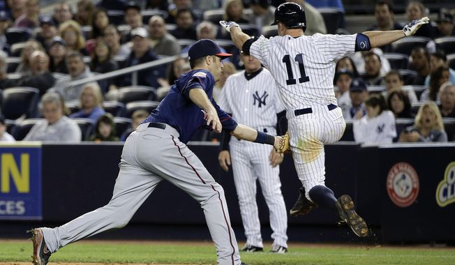 Minnesota Twins first baseman Joe Mauer, left, tags out New York Yankees&#x27; Brett Gardner (11) as Gardner sprints down the first baseline on a ground ball during the eighth inning on Friday, May 30, 2014, in New York. The Twins won 6-1. (AP Photo/Julie Jacobson)
