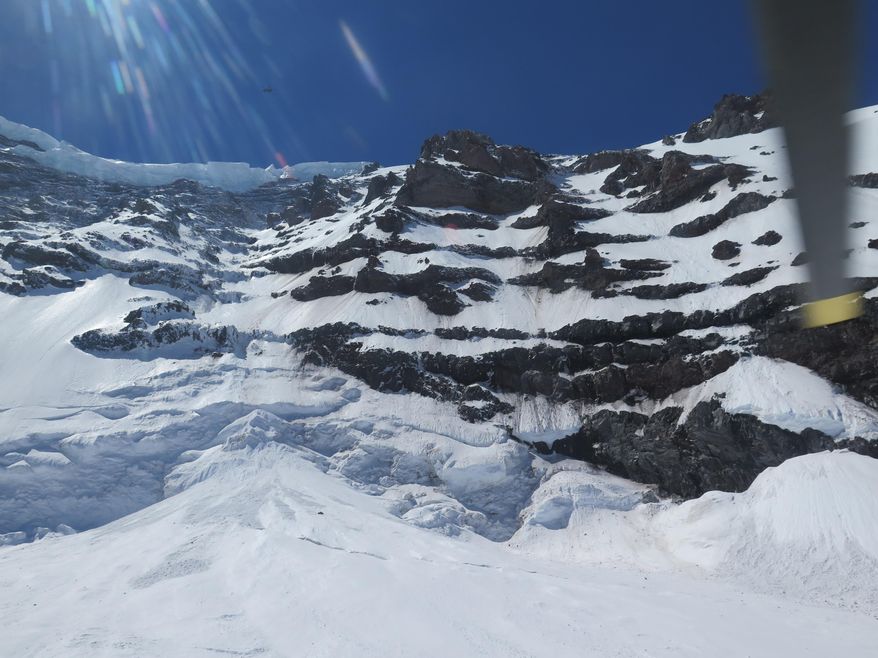 This photo provided by the National Parks Service, shows the Liberty Ridge Area of Mount Rainier as viewed from the Carbon Glacier, Saturday, May 31, 2014, in Washington state. Six climbers missing on Mount Rainier are presumed dead after helicopters detected pings from emergency beacons buried in the snow thousands of feet below their last known location, a national park official said Saturday. (AP Photo/National Park Service)