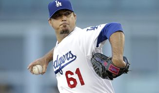 Los Angeles Dodgers starting pitcher Josh Beckett throws against the Pittsburgh Pirates during the first inning of a baseball game Friday, May 30, 2014, in Los Angeles. (AP Photo/Jae C. Hong)