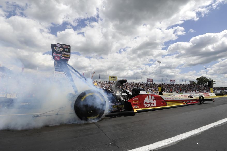 In this photo provided by NHRA, Top Fuel driver Doug Kalitta secures the No. 1 qualifying position in his Mac Tools dragster at the 45th annual Toyota NHRA Summernationals Saturday, May 31, 2014, at Old Bridge Township Raceway Park in Englishtown, N.J. (AP Photo/NHRA, Marc Gewertz)
