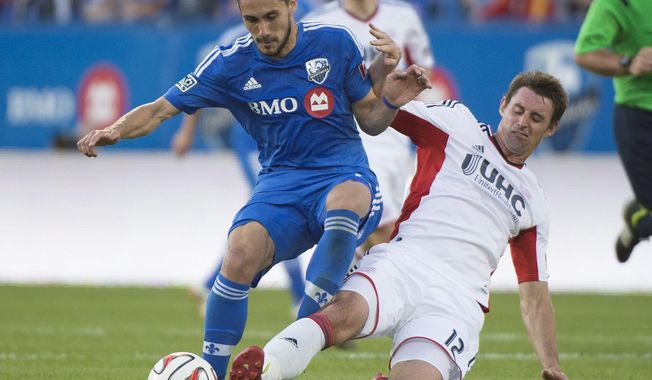 Montreal Impact&#x27;s Issey Nakajima-Farran, left, battles for the ball against New England Revolution&#x27;s Andy Dorman during first half MLS soccer action in Montreal, Saturday, May 31, 2014. (AP Photo/The Canadian Press, Graham Hughes)
