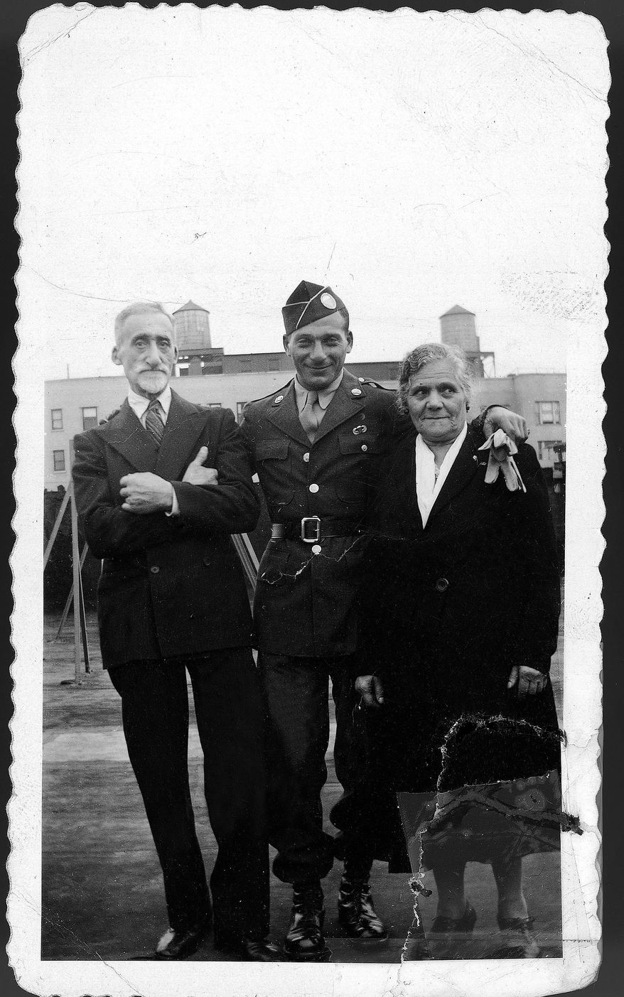 This 1940s era photo provided by Beth J. Harpaz shows her father David Jackendoff, in Army uniform, posing with his parents, Harry and Bella, in New York. Jackendoff parachuted into Normandy with the 101st Airborne on D-Day, June 6, 1944. Though he died in 1993, wartime radio interviews with him and a TV interview on the 40th anniversary of D-Day preserved his stories. (AP Photo/Courtesy of Beth J. Harpaz)