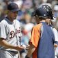Detroit Tigers starting pitcher Max Scherzer, left, is pulled by Tigers manager Brad Ausmus, right, in the seventh inning of a baseball game against the Seattle Mariners, Sunday, June 1, 2014, in Seattle. (AP Photo/Ted S. Warren)