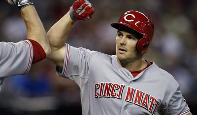 Cincinnati Reds left fielder Chris Heisey (28) celebrates after hitiing a solo home run against the Arizona Diamondbacks in the fith inning during a baseball game, Sunday, June 1, 2014, in Phoenix. (AP Photo/Rick Scuteri)