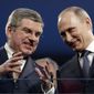 International Olympic Committee President Thomas Bach, left, and Russian President Vladimir Putin watch the closing ceremony of the 2014 Winter Olympics, Sunday, Feb. 23, 2014, in Sochi, Russia. (AP Photo/Charlie Riedel)