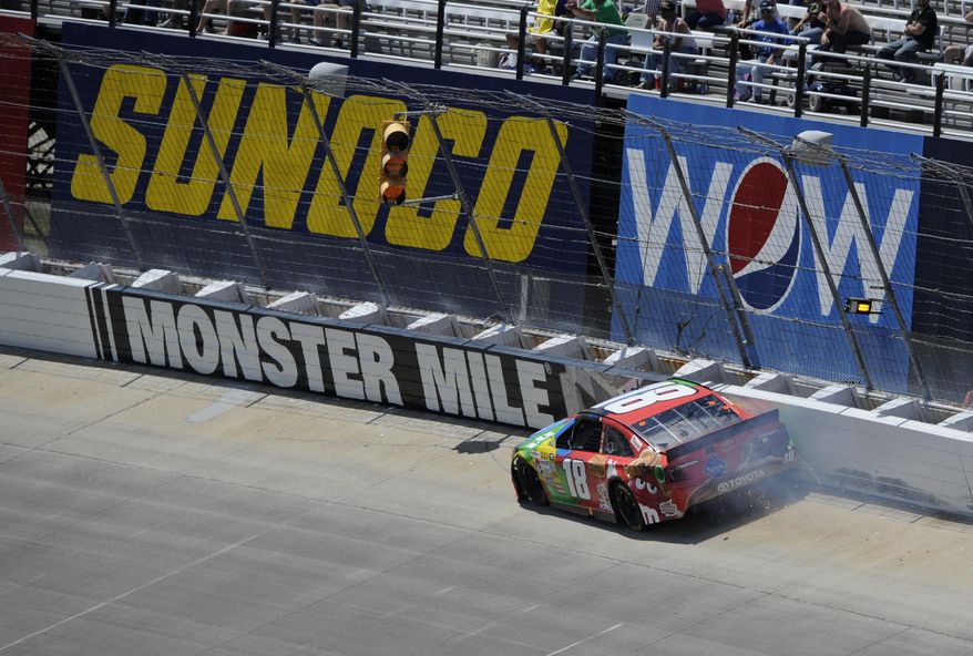 Kyle Busch wrecks along the wall during the NASCAR Sprint Cup Series auto race, Sunday, June 1, 2014, at Dover International Speedway in Dover, Del. (AP Photo/Nick Wass)