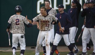 The Pepperdine bench comes out to celebrate a go-ahead run by Hutton Moyer (2) in the seventh inning of an NCAA college baseball tournament regional game against Cal Poly on Saturday, May 31, 2014, in San Luis Obispo, Calif. (AP Photo/Aaron Lambert)