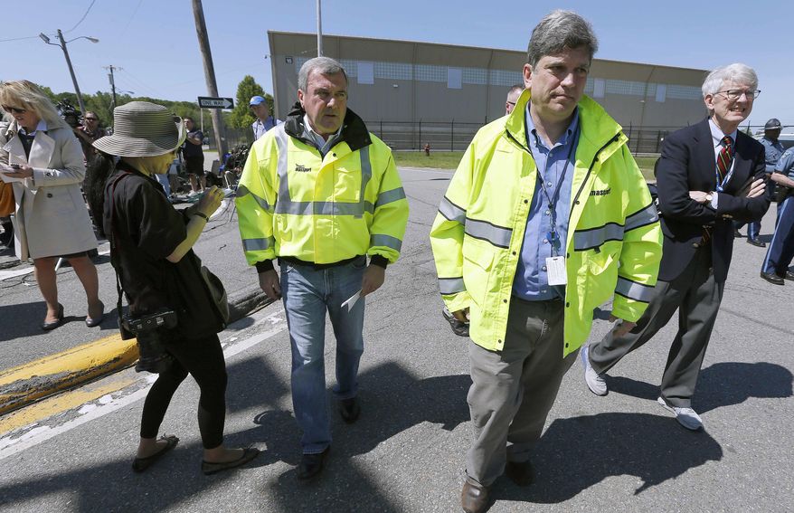 Massachusetts Port Authority Director of Aviation Ed Freni, center left; Director of Media Relations Matthew Brelis, center, and CEO Thomas P. Glynn, right, walk back to the civil aviation terminal after speaking with reporters at Hanscom Field in Bedford, Mass., Sunday, June 1, 2014. Seven people were killed, including Philadelphia Inquirer co-owner Lewis Katz, in a fiery plane crash as the aircraft was leaving Hanscom Field Saturday night. (AP Photo/Michael Dwyer)