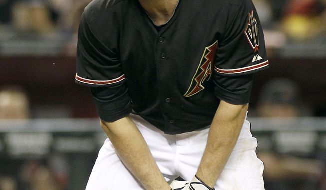 Arizona Diamondbacks&#x27; A.J. Pollock reacts after being hit in the hand by Cincinnati Reds pitcher Johnny Cueto during the eighth inning of a baseball game, Saturday, May 31, 2014, in Phoenix. The Reds defeated the Diamondbacks 5-0. (AP Photo/Ralph Freso)