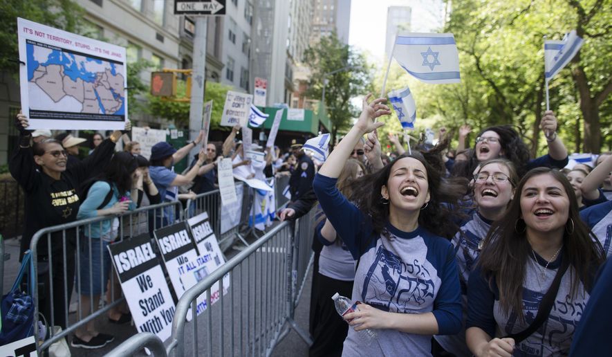 Marchers cheer as they pass along a barricade separating them from anti-Boycott, Divestment and Sanctions (BDS) movement protestors during the Celebrate Israel Parade, Sunday, June 1, 2014, in New York. Among the 35,000 marchers were New York Gov. Andrew Cuomo, New York City Mayor Bill de Blasio, Israeli diplomats and members of the Knesset, Israel&#x27;s parliament. (AP Photo/John Minchillo) ** FILE **