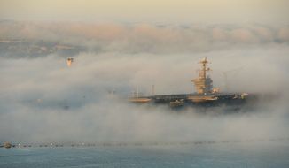 The aircraft carrier USS Carl Vinson (CVN 70) is enveloped in fog Feb. 11, 2014, as it sits in its berth in San Diego. (DoD photo by Glenn Fawcett/Released)