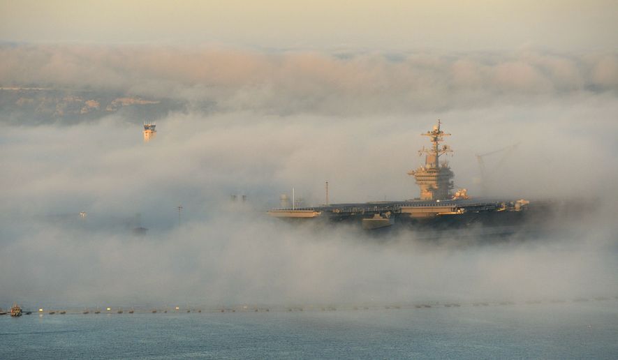 The aircraft carrier USS Carl Vinson (CVN 70) is enveloped in fog Feb. 11, 2014, as it sits in its berth in San Diego. (DoD photo by Glenn Fawcett/Released)
