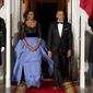 FILE - This Feb. 11, 2014 file photo shows President Barack Obama and first lady Michelle Obama arrive at the North Portico of the White House in Washington to greet French President François Hollande, who is arriving for a State Dinner. (AP Photo/ Evan Vucci, File)