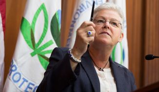 Environmental Protection Agency Administrator Gina McCarthy prepares to sign a plan to cut carbon emissions from power plants. (Associated Press)