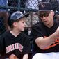 Baltimore Orioles&#39; Cal Ripken explains to his son Ryan the duties of bat boy before a spring training game against the Minnesota Twins in Fort Lauderdale, Fla. Saturday, March 3, 2001.  Ripken cracked his ribs before arriving at training camp and did not play in the game.(AP Photo/Roberto Borea)