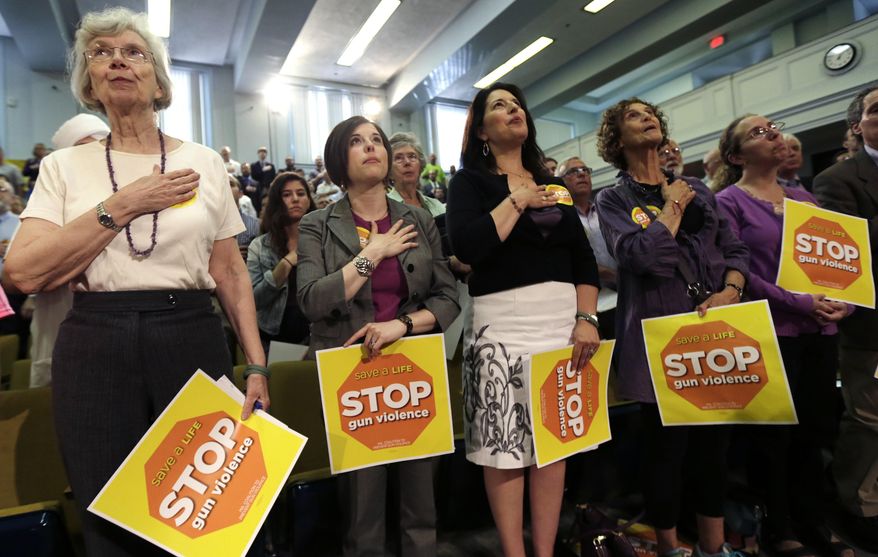 The gallery stands for the Pledge of Allegiance prior to a hearing on gun rights laws at the Statehouse in Boston, Tuesday, June 3, 2014. Supporters and opponents of tighter gun control measures gathered at the Statehouse for a public hearing on a wide-ranging gun bill. (AP Photo/Charles Krupa)