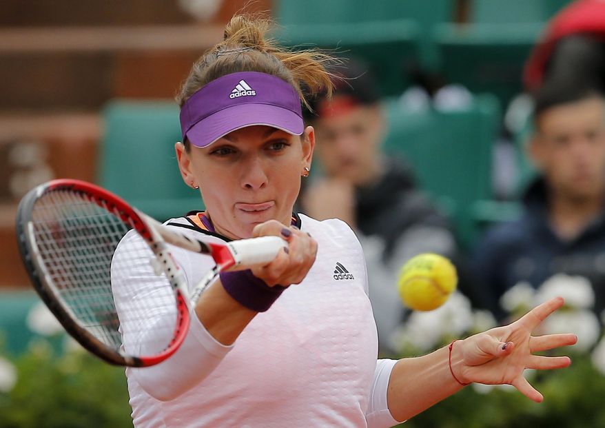 Romania's Simona Halep returns the ball to Russia's Svetlana Kuznetsova during their quarterfinal match of the French Open tennis tournament at the Roland Garros stadium, in Paris, France, Wednesday, June 4, 2014. (AP Photo/Michel Spingler)