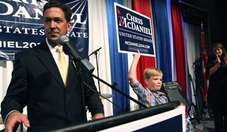 Chris McDaniel addresses his supporters as his son Cambridge, 7, joins him on the stage at the Lake Terrace Convention Center in Hattiesburg, Miss., on election night. With a third candidate on the ballot, neither Mr. Cochran nor Mr. McDaniel managed to get at least 50 percent plus one vote, the threshold to win outright and avoid a June 24 runoff.
(Associated Press)