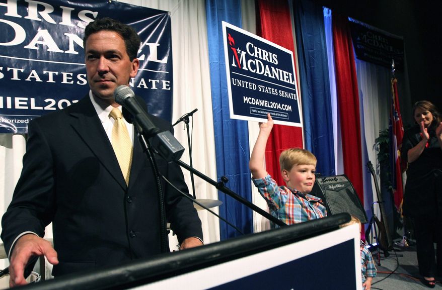 Chris McDaniel addresses his supporters as his son Cambridge, 7, joins him on the stage at the Lake Terrace Convention Center in Hattiesburg, Miss., on election night. With a third candidate on the ballot, neither Mr. Cochran nor Mr. McDaniel managed to get at least 50 percent plus one vote, the threshold to win outright and avoid a June 24 runoff.
(Associated Press)