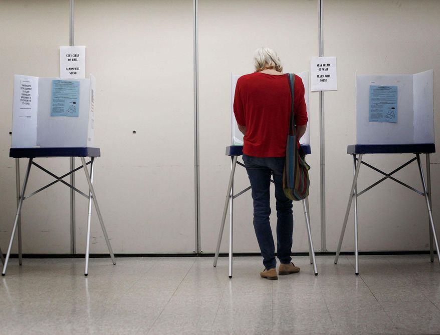 Lori Fisher of Arroyo Grande, Calif., casts her vote in the primary election Tuesday, June 3, 2014, at the San Luis Obispo South County Regional Center in San Luis Obispo, Calif. California holds its primaries under its unusual all-candidates system, in which the top two finishers, regardless of party, face off in November. (AP Photo/The Santa Maria Times, Daniel Dreifuss)