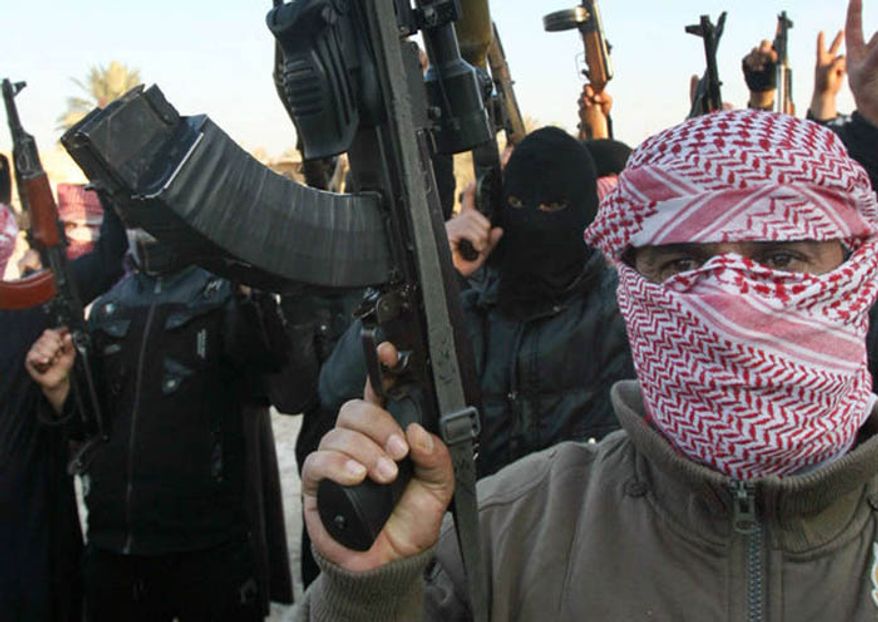 ** FILE ** Al Qaeda gunmen gather in the streets of Fallujah, Iraq, Jan. 2014. (Associated Press)