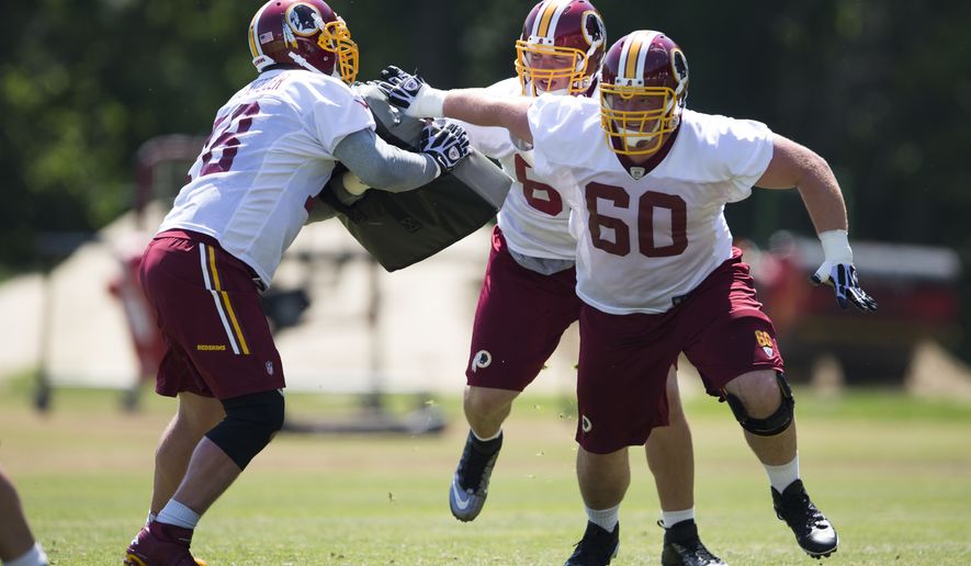 Washington Redskins rookie guard Spencer Long, right, tackle Tom Compton, center, and center Kory Lichtensteiger take part in drills during an NFL football practice at Redskins Park, on Wednesday, June 4, 2014, in Ashburn, Va. (AP Photo/ Evan Vucci)  