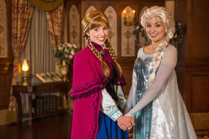 This undated image released by Disney shows Disney characters Anna, left, and her sister Elsa from the animated film "Frozen" at Princess Fairytale Hall at Walt Disney World Resort in Lake Buena Vista, Fla. Princess Fairytale Hall features walls of stone and stained glass windows, a spacious gallery adorned with portraits of Disney princesses and elegantly finished rooms where guests can meet Anna & Elsa, Cinderella, Rapunzel and other princesses. Wait times to meet the sisters stretches for hours and reservations are snapped up as soon as they become available, part of a frenzy for all things "Frozen." (AP Photo/Disney, Matt Stroshane)